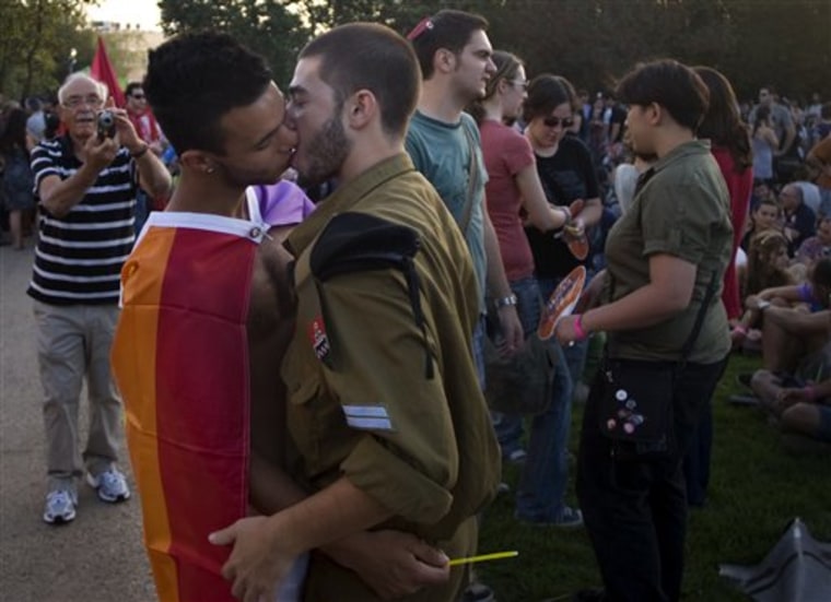 An Israeli couple kisses during the annual gay pride parade in Jerusalem on Thursday.  